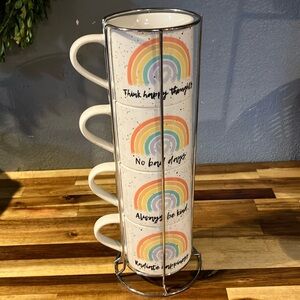 Set of 4 Coco and Lola coffee mugs in wire rack.
